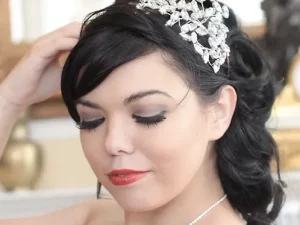 Crystal side tiara with sparkling crystal leaves and floral detailing, handmade bridal headpiece worn to the side of an updo hairstyle